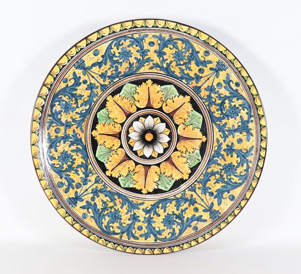 A large Sciacca majolica plate with polychrome floral and plant motifs. Signed Nico Nicosia 1965.