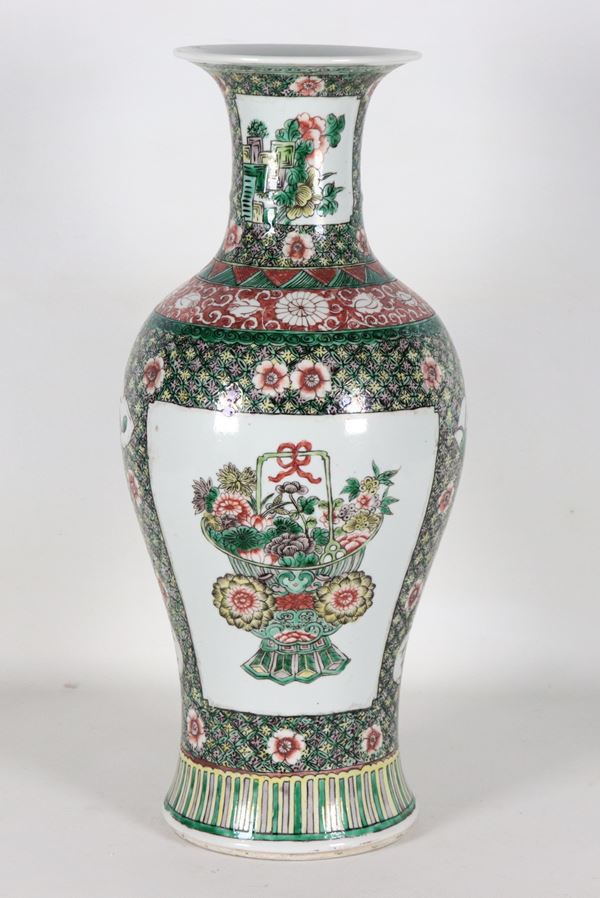 Chinese porcelain vase entirely decorated with polychrome enamels featuring oriental flower motifs on a green background