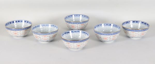 Set of six Chinese porcelain rice bowls, decorated with blue rice grain motifs on a white background.