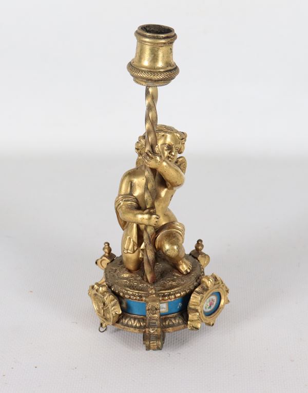 Antique small French candlestick in gilded bronze, chiseled and embossed, with a cherub figure and Sèvres porcelain plaques