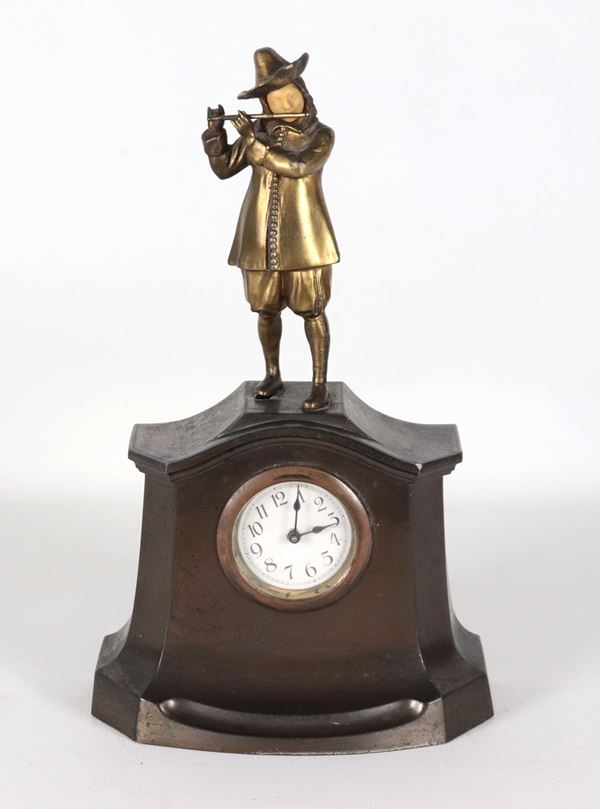 Antique small German patinated bronze table clock, with small sculpture of a "Flute Player" and white enamel dial
