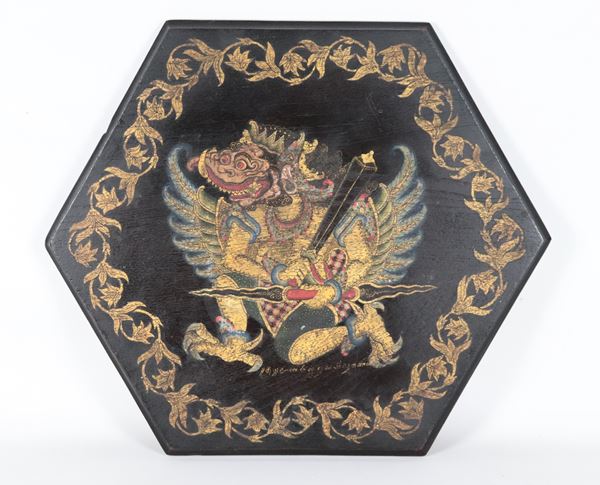 Hexagonal panel in black lacquered wood, with "Divinity" painted in various polychromes