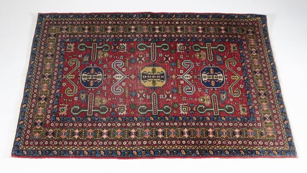 Shirvan Persian rug with geometric designs on a red background