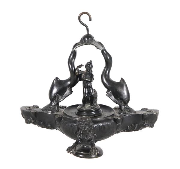 Roman Grand Tour lamp in patinated bronze, with handles in the shape of dolphins, a sculpture of a faun in the centre and lions' heads