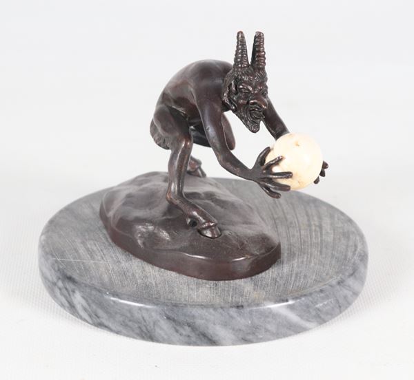 Paul Ducois - Signed. "The Devil", a small antique patinated bronze sculpture, supported by a round marble base from a later period.
