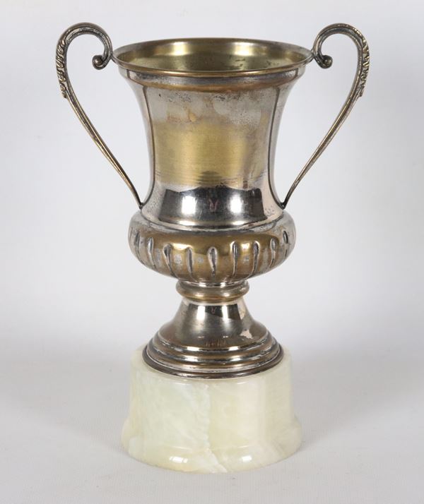 Silver-plated and embossed metal cup supported by an alabaster marble base
