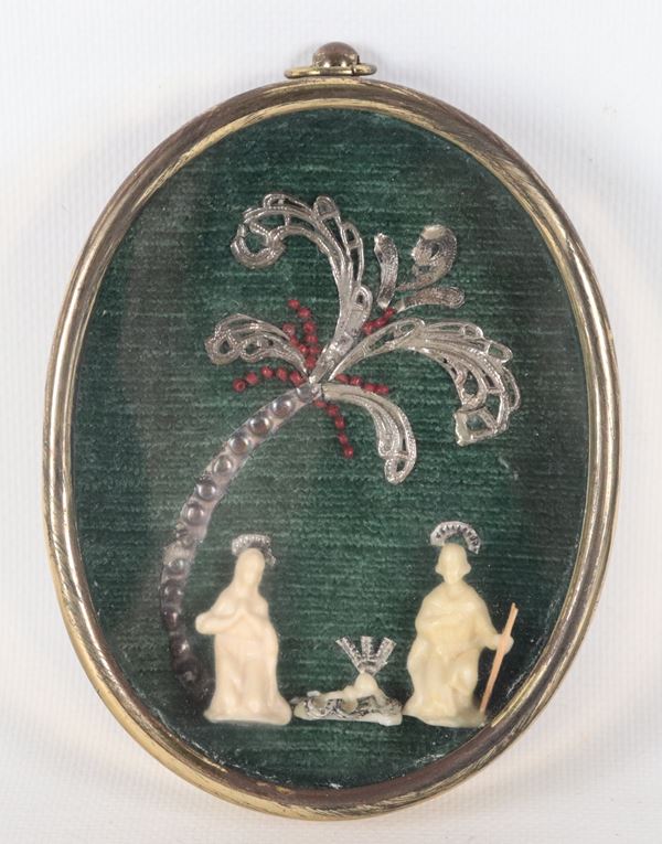 Oval gold-plated metal frame with a "Nativity" and silver palm inside