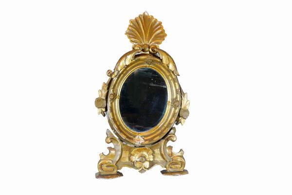 Oval table mirror in lacquered and gilded wood
