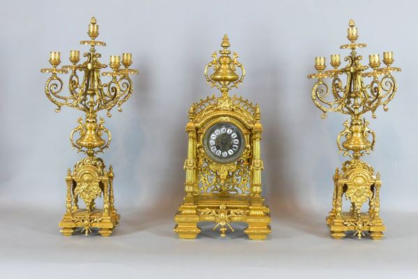 French triptych: clock and two five-flame candelabra