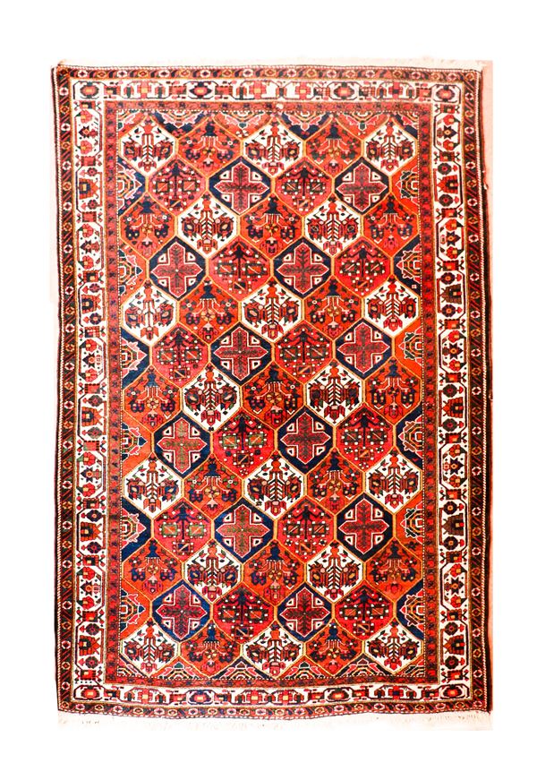 Persian carpet with geometric designs on a red background