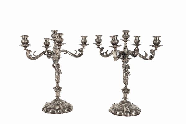 Pair of silver candelabra supported by "Putti with cornucopias". 4830 grams