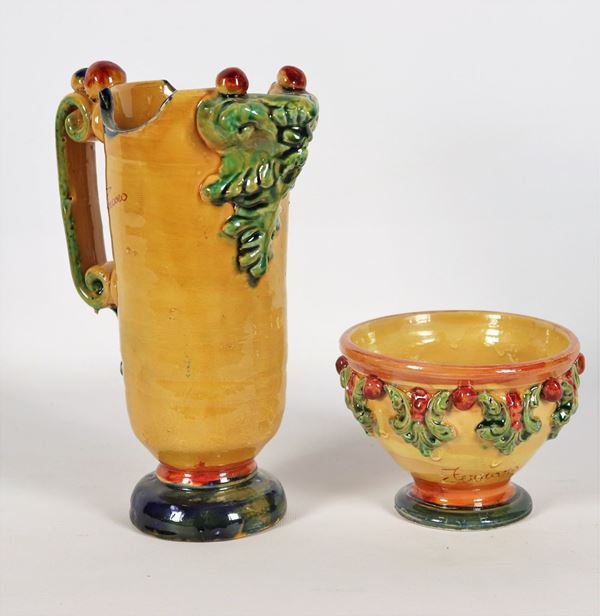 Pitcher and cup in majolica and enamelled terracotta. Signed Ferraro