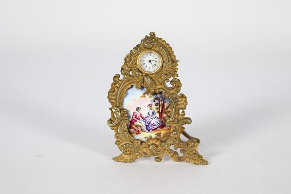 Antique small table clock in gilt bronze with enamel plate
