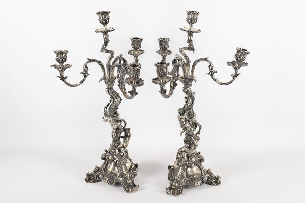 Coppia di antichi candelabri in bronzo argentato a quattro fiamme