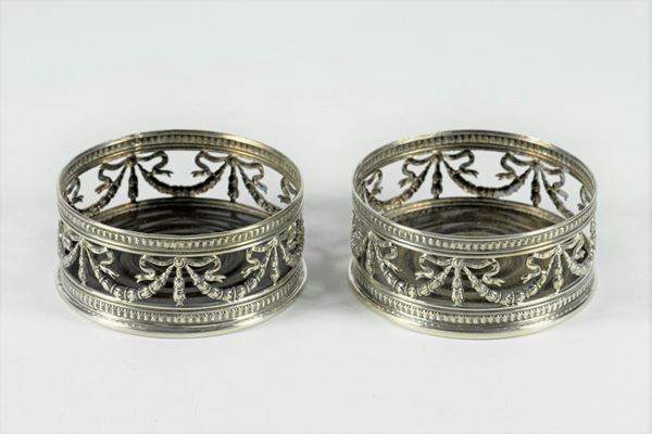 Pair of bottle holders in embossed metal