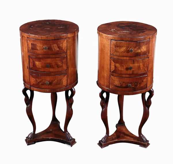 Pair of walnut "drum" bedside tables supported by three swan sculptures