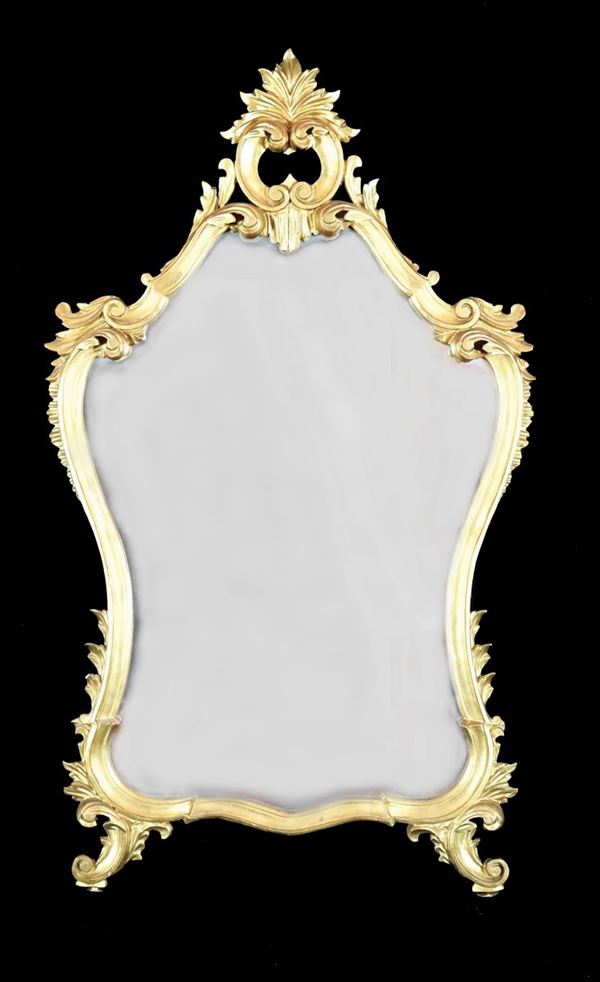 Louis XV line mirror in gilded and carved wood