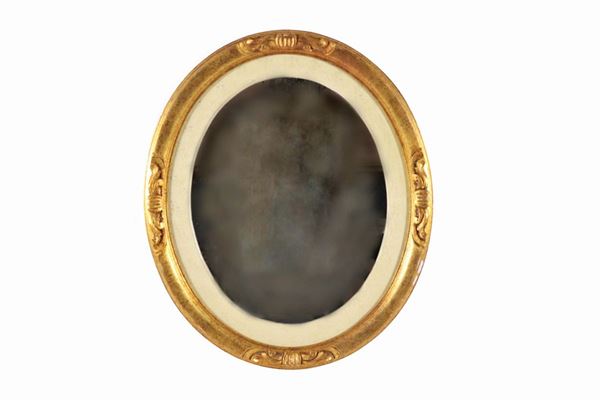 Oval mirror in gilded and carved wood