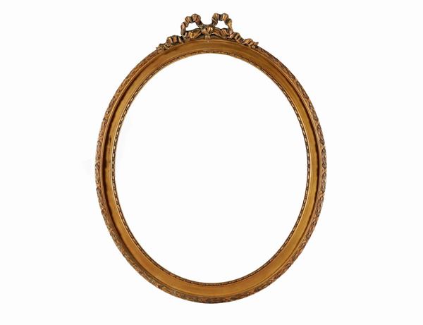 Oval frame in gilded wood with carvings with Louis XVI motifs