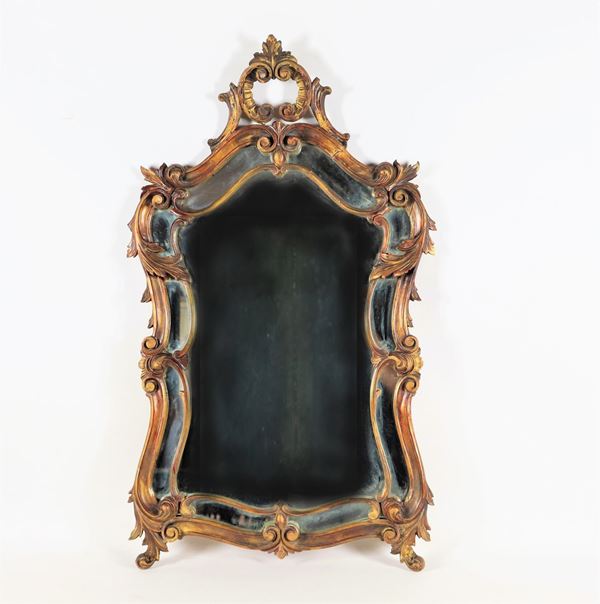 Louis XV line mirror in gilded and carved wood