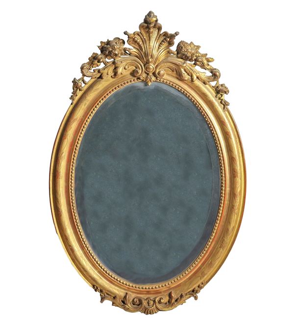French oval mirror in gilded wood