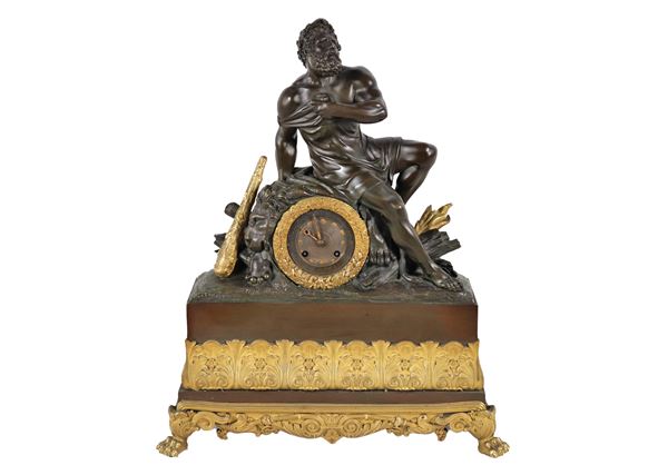 Antique French table clock with sculpture depicting "Hercules and the lion" in patinated and gilded bronze