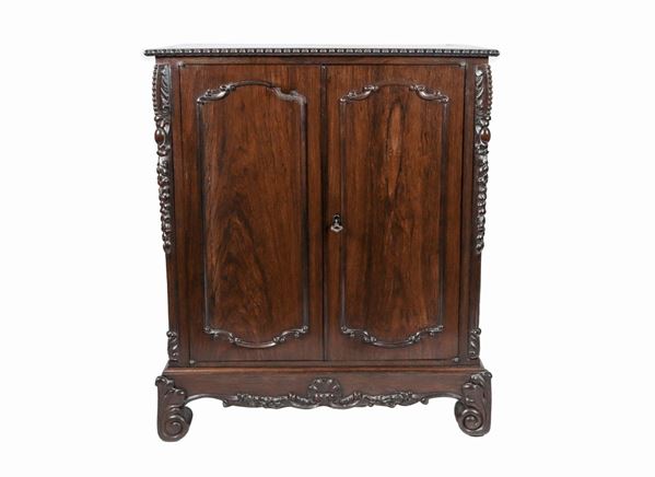 Sideboard with two doors in rosewood, with profiles and uprights in carved wood