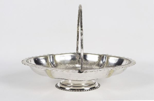 Antique oval sheffield basket with shaped handle and chiseled bottom with floral motifs
