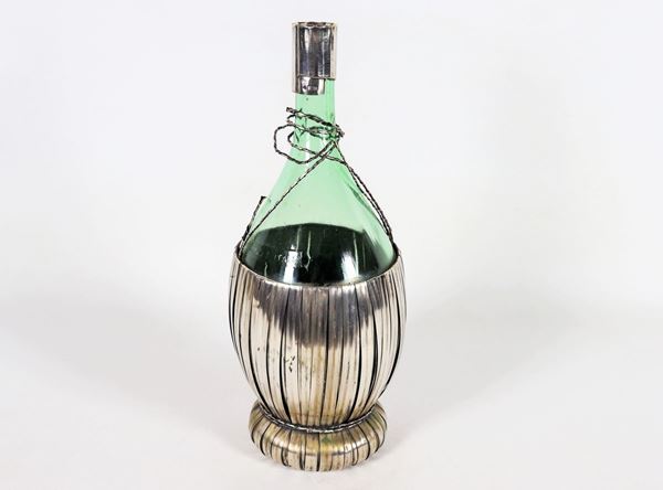 Red wine flask in glass with silver stuffing