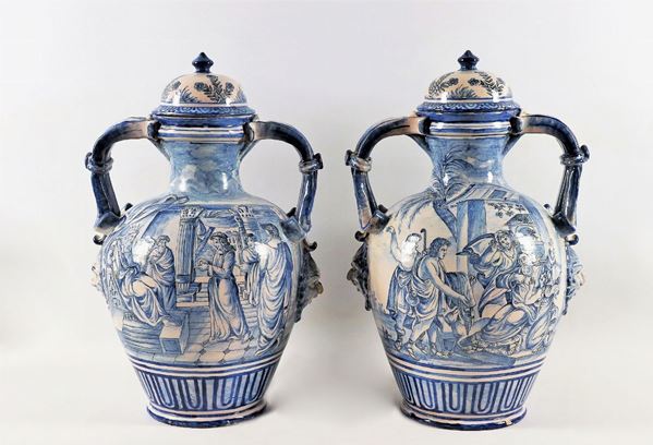 Pair of two-handled vases with lids in enamelled majolica from Savona decorated in blue monochrome with biblical historical scenes and landscapes with villages
