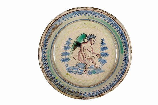 Large fangotto plate in glazed majolica with "Angel with trees" painted in the center of the scene