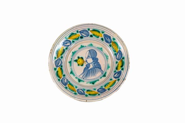 Laterza glazed majolica wall plate with colorful decorations and a lady's face in the center