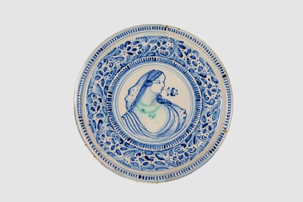 Crispina in Laterza glazed majolica decorated in blue with leaf motifs and a portrait of a lady in the center
