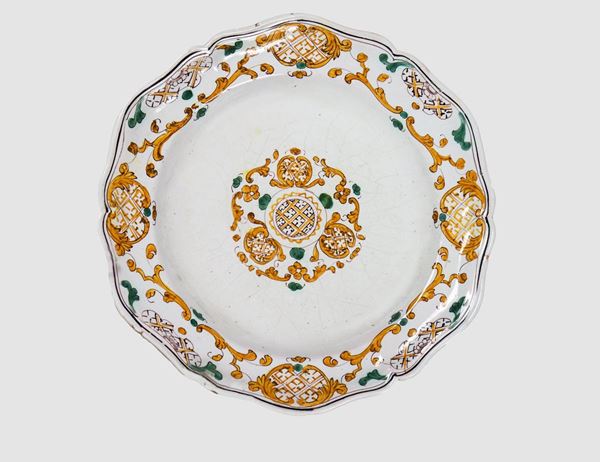 Wall plate in glazed majolica "Reggia di Caserta" with yellow and green decorations with geometric and floral scroll motifs
