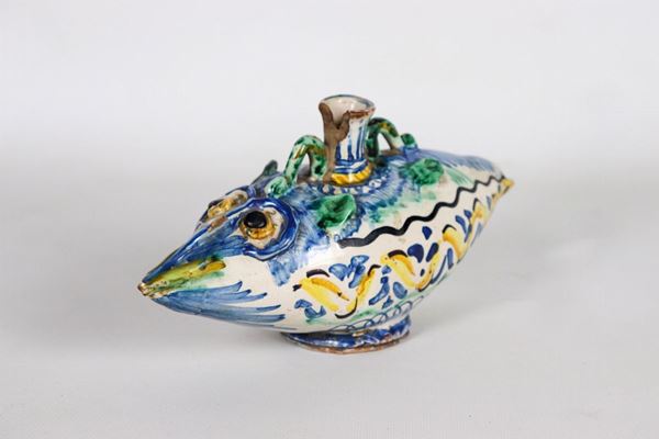 "Rython" shaped bottle in glazed majolica decorated with blue and green leaf motifs