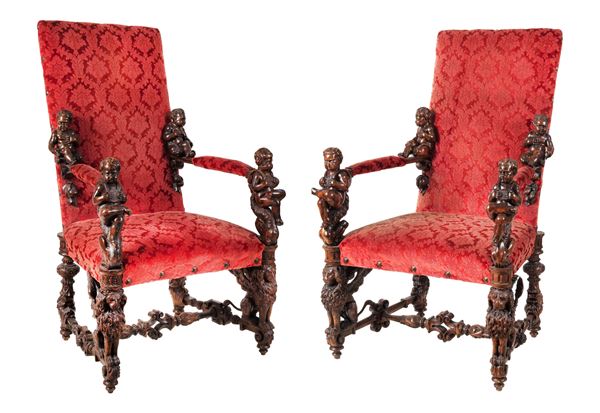 Pair of armchairs in the manner of Andrea Brustolon in fruit wood entirely carved with motifs of sculptures of cherubs, seated lions and grotesques