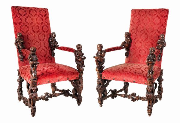 Pair of armchairs in the manner of Andrea Brustolon in fruit wood entirely carved with motifs of sculptures of cherubs, seated lions and grotesques