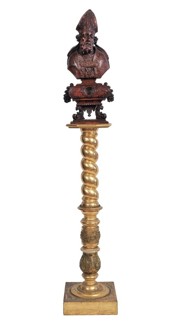 Richly carved "San Nicola" fruit wood sculpture, supported by a turned column in gilded wood