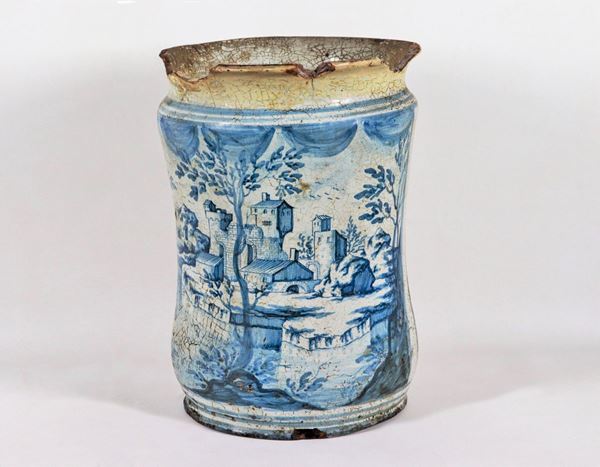 Albarello in glazed majolica with decorations painted in blue with a landscape motif. Lacks and defects