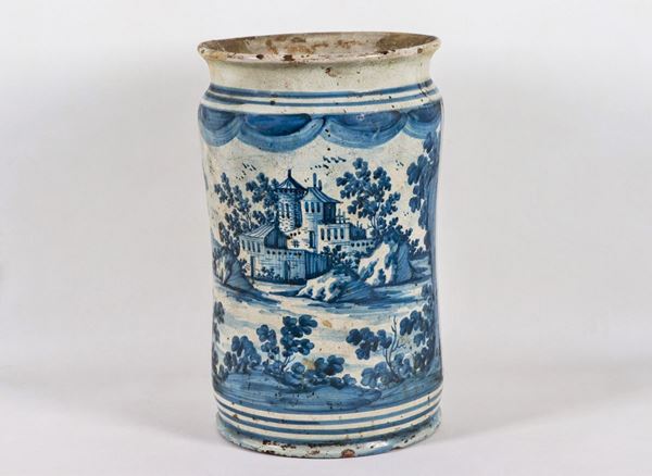 Albarello in glazed majolica with decorations painted in blue with landscape motifs, edge with restorations