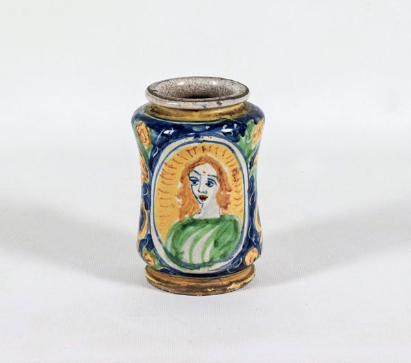 Small apothecary albarello in glazed majolica with decorations painted in intertwining flowers and leaves and medallion with bust of a lady