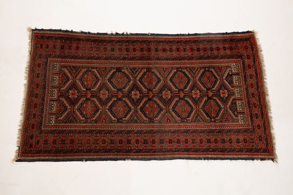 Persian carpet with red background with geometric motifs