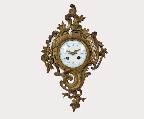 Antique small French cartel clock in gilded and chiseled bronze with Louis XV motifs