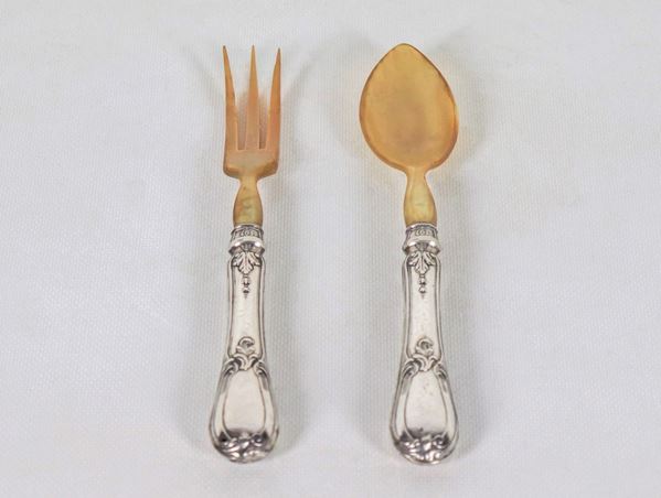 Pair of two antique salad servers with chiseled and embossed silver handles