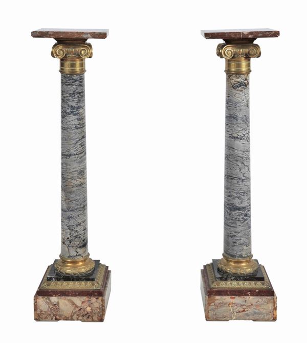 Pair of columns in Caristo wrapped cipollino marble and various brecciated marbles, with Ionic capitals in gilded, embossed and chiseled bronze