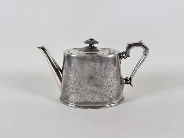 Pewter teapot chiseled with oriental flower and leaf motifs