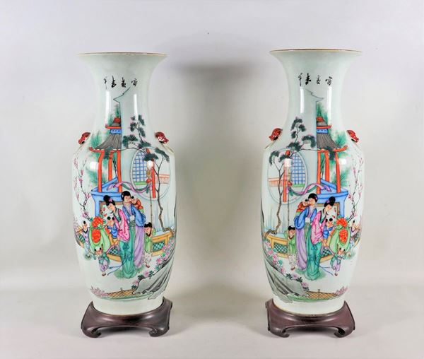 Pair of trumpet vases in porcelain with polychrome enamel relief decorations with motifs of oriental life scenes and inscriptions on the back