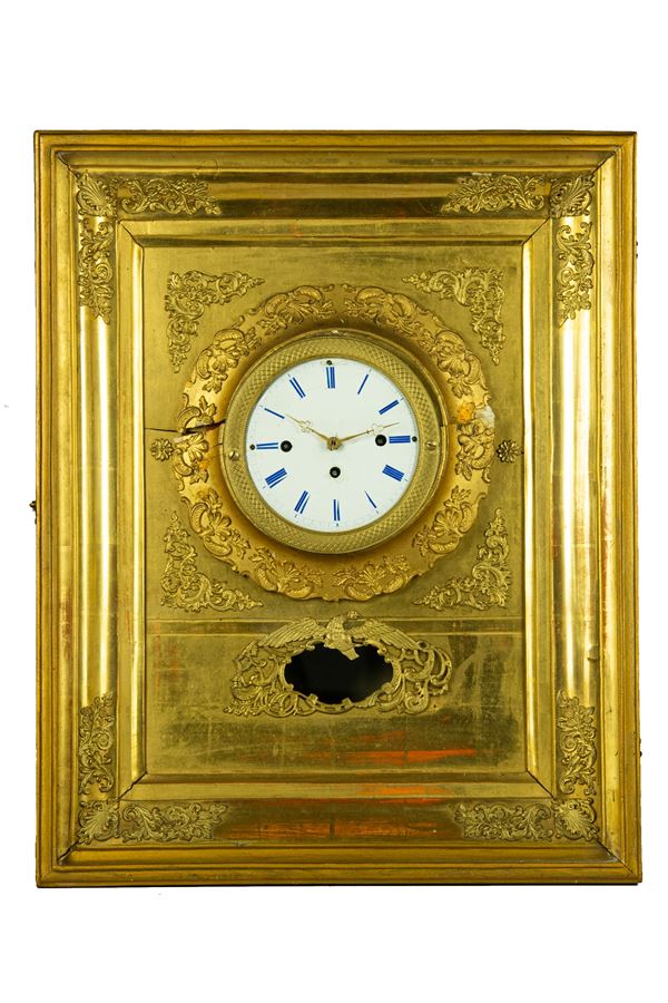 Wall clock in gilded wood