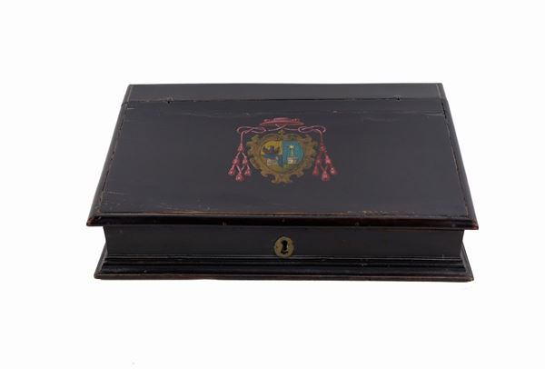 Small travel desk in ebonized wood with the cardinal's coat of arms in the center