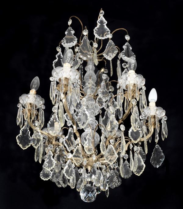 Lampadario francese in bronzo dorato di linea Luigi XV con prismi in cristallo a motivi di foglie e gocce, 6 luci